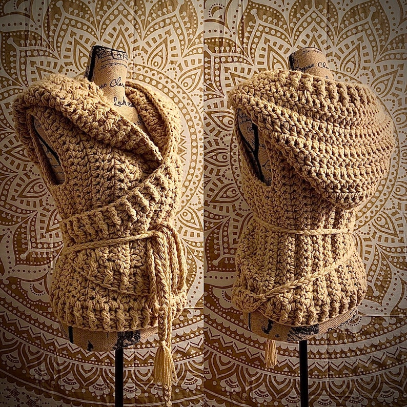May include: Two crocheted vests with hoods, one in a wrap style and the other in a straight style. Both vests are a light beige color and are displayed on mannequins against a background of a white and gold mandala pattern.