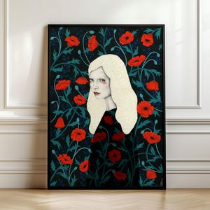 May include: A framed wall art print featuring a portrait of a person with long, pale blonde hair set against a dark background filled with vibrant red poppy flowers and deep teal green foliage, enclosed in a simple black frame.