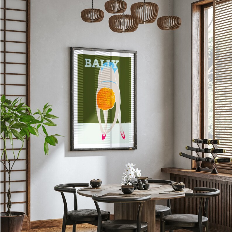 May include: A framed poster with a green background and a woman in a blue swimsuit diving into a pool of orange water. The poster has the word "BALLY" printed in white letters at the top.