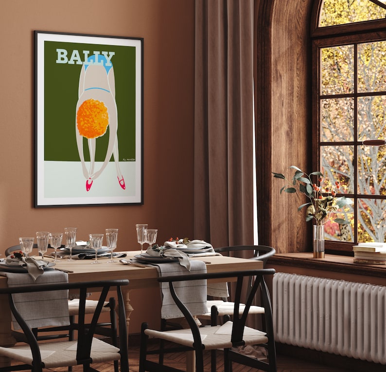 May include: A framed poster with the word "BALLY" in white text on a green background. The poster features a stylized illustration of a person in a blue swimsuit bending over with their head down. The person has orange hair and is wearing red shoes.