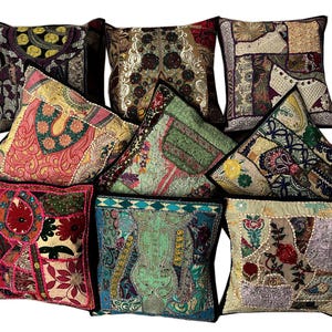 May include: Nine colorful throw pillows with intricate embroidery and patchwork designs. The pillows are made of various fabrics and feature a mix of colors, including red, green, blue, and gold.