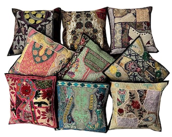 May include: Nine colorful throw pillows with intricate embroidery and patchwork designs. The pillows are made of various fabrics and feature a mix of colors, including red, green, blue, and gold.