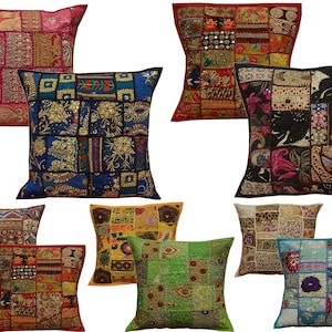 May include: A collection of decorative throw pillows with patchwork designs. The pillows feature a variety of colors, including red, blue, green, and gold. Each pillow has a unique pattern, with squares and rectangles of fabric sewn together.