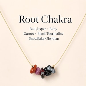 May include: A gold chain necklace with a pendant featuring a collection of colorful gemstones. The gemstones include red jasper, ruby, garnet, black tourmaline, and snowflake obsidian. The text "Root Chakra" is displayed above the gemstones.