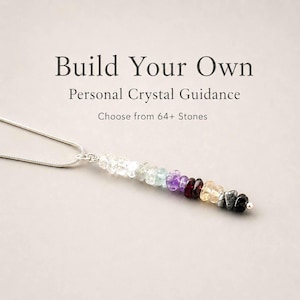 May include: A silver necklace with a pendant of colorful gemstones. The pendant features a gradient of colors, including clear, green, purple, red, yellow, and black stones. Text reads: "Build Your Own Personal Crystal Guidance. Choose from 64+ Stones."