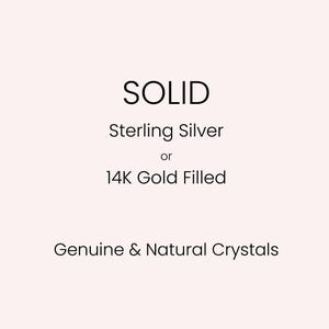 Może przedstawiać: Obraz z tekstem, kt&oacute;ry brzmi "SOLID", "Sterling Silver or 14K Gold Filled" i "Genuine & Natural Crystals" na jasnor&oacute;żowym tle. Tekst jest prostą, nowoczesną czcionką.