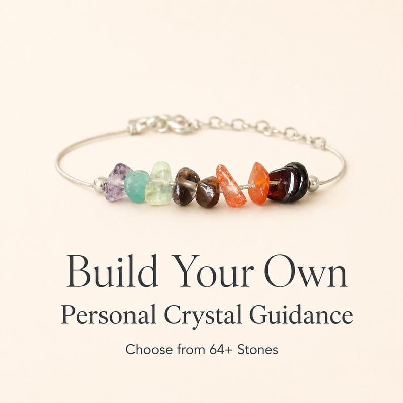 May include: A silver bracelet featuring a row of colorful, raw crystal stones. The crystals include shades of purple, blue, green, brown, orange, and black. Text on the image reads "Build Your Own Personal Crystal Guidance" and "Choose from 64+ Stones."