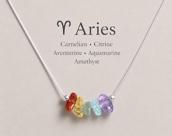 May include: A silver chain necklace featuring a row of five small, polished, multi-colored gemstone chips in red, yellow, green, blue, and purple. Above the stones, the text reads Aries, Carnelian, Citrine, Aventurine, Aquamarine, Amethyst.