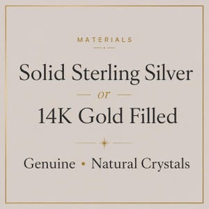 May include: A square graphic with a light beige background and a thin gold border. The text reads: MATERIALS, Solid Sterling Silver or 14K Gold Filled, and Genuine Natural Crystals. The design includes small gold lines and a star icon.