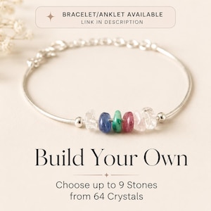May include: A silver bracelet with a series of colorful gemstone beads. The bracelet features clear, blue, green, and pink stones. Text at the bottom reads "Build Your Own" and "Choose up to 9 Stones from 64 Crystals."