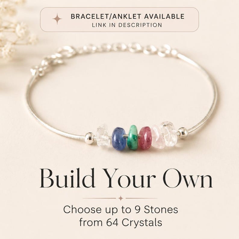 May include: A silver bracelet with a series of colorful gemstone beads. The bracelet features clear, blue, green, and pink stones. Text at the bottom reads "Build Your Own" and "Choose up to 9 Stones from 64 Crystals."