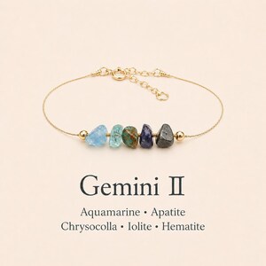 May include: A gold-colored chain bracelet featuring five colorful gemstone beads: aquamarine, apatite, chrysocolla, iolite, and hematite. The text "Gemini II" and the names of the gemstones are below the bracelet.