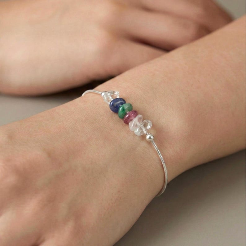 Close up of dainty sterling silver crystal bracelet on wrist, raw gemstone chip beads with soft natural lighting, minimalist everyday jewelry gift
