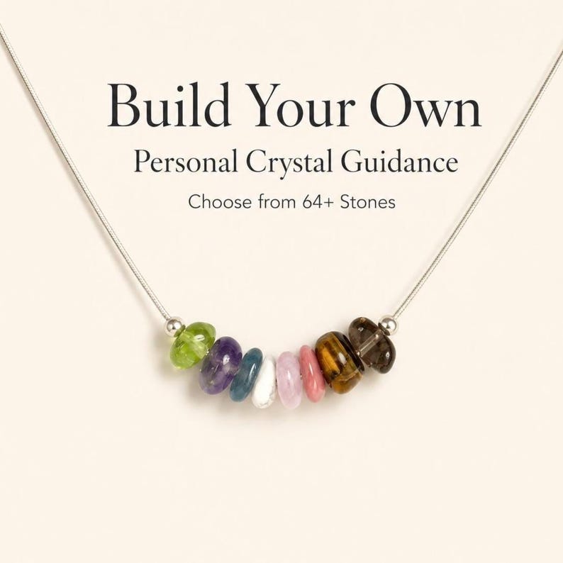 May include: A silver necklace with a row of colorful gemstones. The necklace features a variety of stones in shades of green, purple, blue, white, pink, brown, and clear. Text at the top reads "Build Your Own Personal Crystal Guidance".