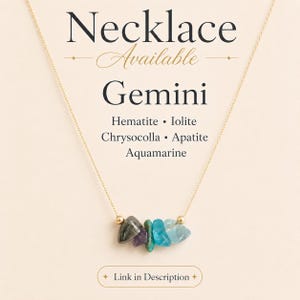 May include: A gold-colored necklace with a pendant featuring a cluster of colorful gemstones. The gemstones include hematite, iolite, chrysocolla, apatite, and aquamarine. The word "Gemini" is displayed above the gemstones.