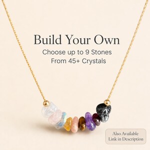 May include: A gold chain necklace with a pendant of colorful crystals. The necklace features a variety of stones, including clear, pink, blue, yellow, brown, and purple. Text on the image reads "Build Your Own" and "Choose up to 9 Stones From 45+ Crystals."