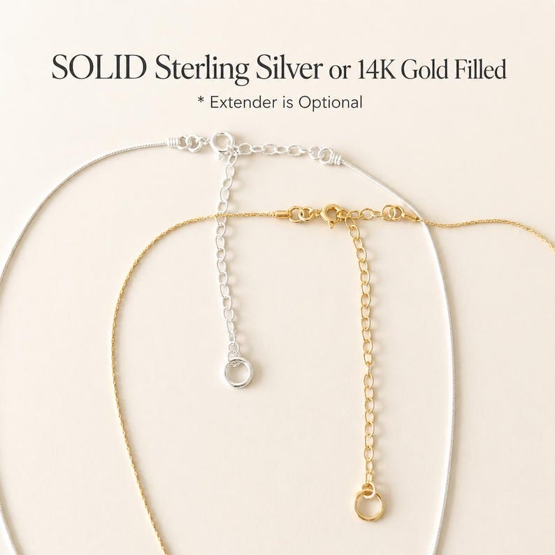May include: Close-up of two necklaces, one silver and one gold, with extender chains. The silver necklace is on the left, and the gold necklace is on the right. Text at the top reads "SOLID Sterling Silver or 14K Gold Filled".
