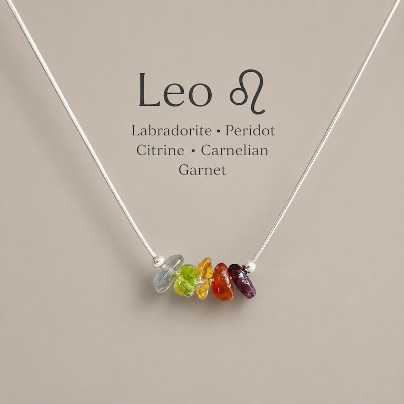 Pu&ograve; includere: Una collana a catena argentata con cinque piccole perle di pietre preziose irregolari e multicolori in blu, verde, giallo, arancione e rosso scuro. Il testo sopra recita: Leo, il simbolo del Leone, Labradorite, Peridoto, Citrino, Corniola, Granato.