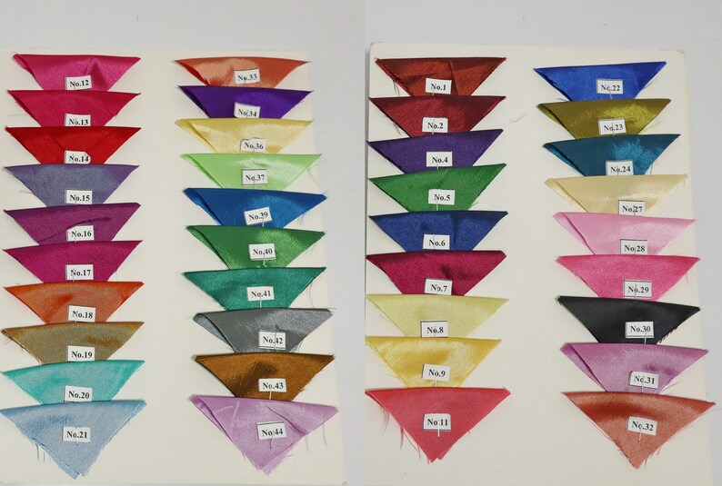 May include: A display of fabric swatches in various colors, arranged in rows. Each swatch is a small, triangular piece of fabric, with a label indicating a number. Colors range from pinks and reds to blues and greens.