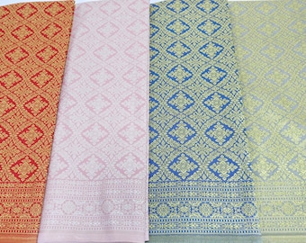 May include: Four fabric swatches with a repeating geometric pattern. The swatches are red, pink, blue, and grey. The pattern is a diamond shape with a floral design inside.