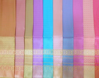May include: A collection of ten vertical fabric panels in various colors including orange, pink, gold, purple, blue, and red. Each panel features a smooth upper section and a lower section decorated with intricate gold geometric patterns.
