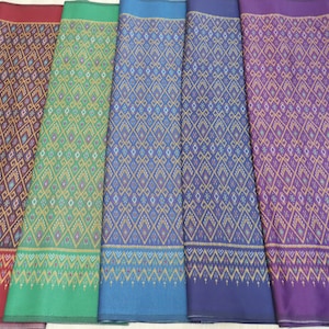 Artificial silk with ikat print fabric, Mudmee print fabric, Ikat pattern polyester silk, Materials for Thai trouser pants and sarong skirt