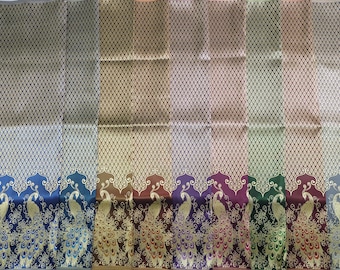 May include: A collection of eight fabric swatches featuring a peacock design. The fabric is a woven silk with a subtle geometric pattern. The peacocks are depicted in gold, blue, green, brown, and purple.