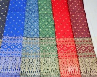May include: A collection of colorful fabric samples with intricate patterns. The fabrics are arranged in a row, with the colors ranging from black to red. The patterns are all different, but they all have a traditional Thai design.