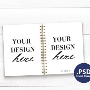 May include: A white notebook with a gold spiral binding. The notebook is open and has the text "YOUR DESIGN here" on both pages. The notebook is 8.5x11 inches and is a PSD Smart Object.