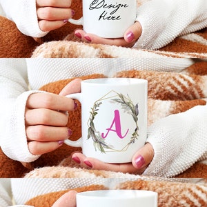 May include: White ceramic mug mockup with the text "Your Design Here". Another mug features a pink letter "A" inside a gold geometric frame with floral accents. A third mug displays "World's Best Mom" in pink and purple.