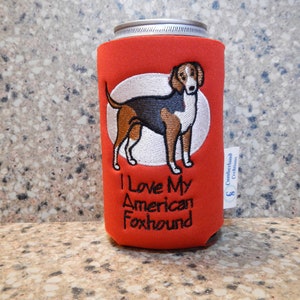 May include: Red can cooler with an embroidered American Foxhound dog and the text "I Love My American Foxhound".