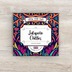 May include: A colourful, patterned box with the text "Grow Your Own Jalapeño Chillies" and the words "Capsicum Annuum" in a smaller font. The box also features a small British flag and the text "Handmade in the UK".