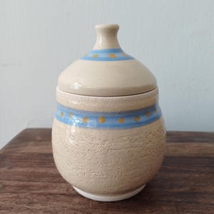 Ceramic decorated lidded jar; Ceramic box with a matching hand painted lid
