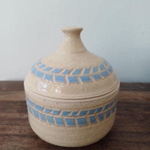 Ceramic decorated lidded jar; Ceramic box with a matching hand carved lid