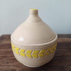 Ceramic carved lidded jar; Ceramic box with a matching lid