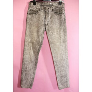 May include: Gray acid wash denim jeans with a straight leg fit.