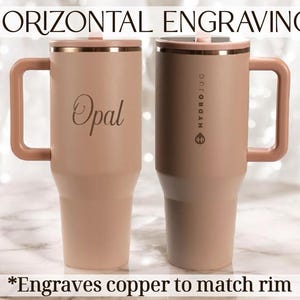 May include: Two insulated travel mugs in a light peach colour with copper-coloured rims and handles. One mug has the name "Opal" engraved on it. The other mug has the text "HYDROJUG" printed vertically. The text "*Engraves copper to match rim" is at the bottom.