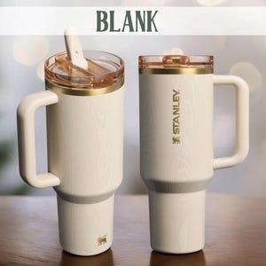 May include: Two cream-colored Stanley travel mugs with handles. One has a clear lid with a straw, the other has a clear lid. Both have gold accents and the Stanley logo. The word "BLANK" is at the top.