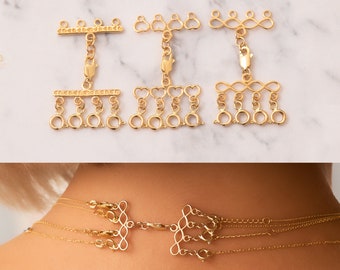 May include: Gold-toned metal necklace extender with a variety of decorative chain links. The extender features a bar with a clasp, a heart-shaped chain, and an infinity symbol chain.