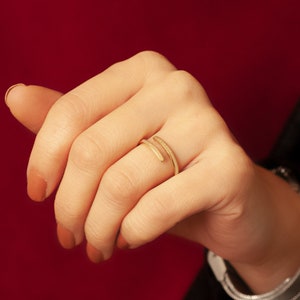 Personalized real gold wrap band with engraved inscription, shown worn on finger.
