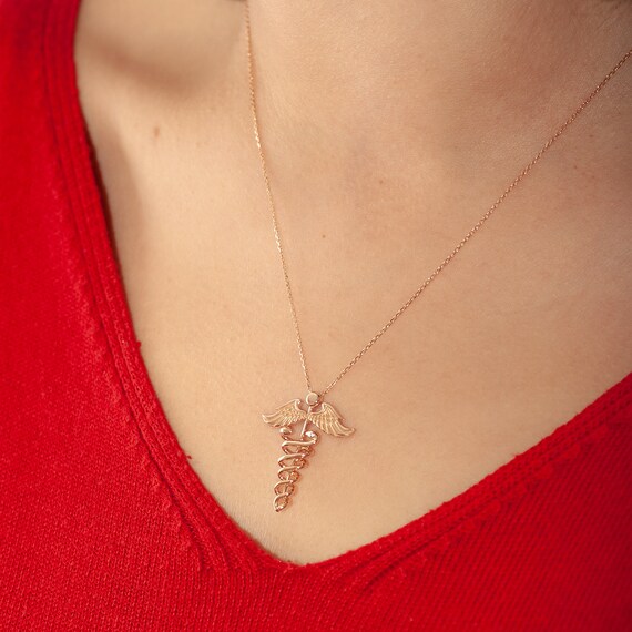 14k Yellow Gold RN Letters And Caduceus Symbol On Latin Cross Pendant 18x12mm 14k Yellow Gold RN Letters And Caduceus Symbol On Latin Cross Pendant 18x12mm