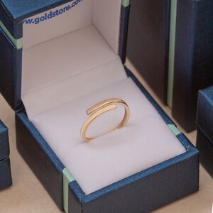Simple solid gold open band ring in presentation box, ready for personalized name or date inscription.