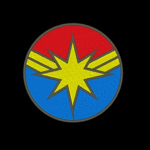 May include: A red, blue, and yellow embroidered patch with a starburst design. The starburst is yellow with a dark outline and has two yellow stripes on each side.