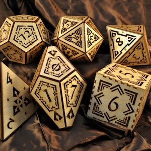 May include: A set of six wooden dice with intricate laser-cut designs. The dice are numbered 1 through 6 and feature a unique geometric pattern.