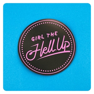 May include: A black circle sticker with a pink dotted border and the text "Girl the Hell Up" in pink.