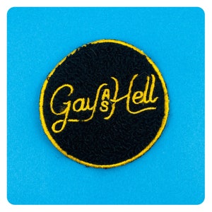 May include: A black and yellow circular patch with the text "Gay's Hell" embroidered in yellow.