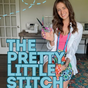 May include: Rainbow-coloured metal sewing scissors with pink handles held in a hand. A blue measuring tape hangs around the neck over a pink tank top and white button-down shirt. The text THE PRETTY LITTLE STITCH is overlaid in large blue letters.