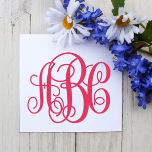 May include: A white card with a pink monogram of the letters "RB" in a cursive script font. The card is surrounded by white and blue flowers.