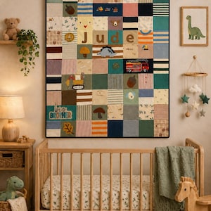 May include: A colourful patchwork quilt with the name "Jude" stitched into it hangs above a wooden cot. The quilt features various fabric squares with patterns and appliqués of a mushroom, dinosaur, and fire engine. A framed dinosaur print is on the wall.