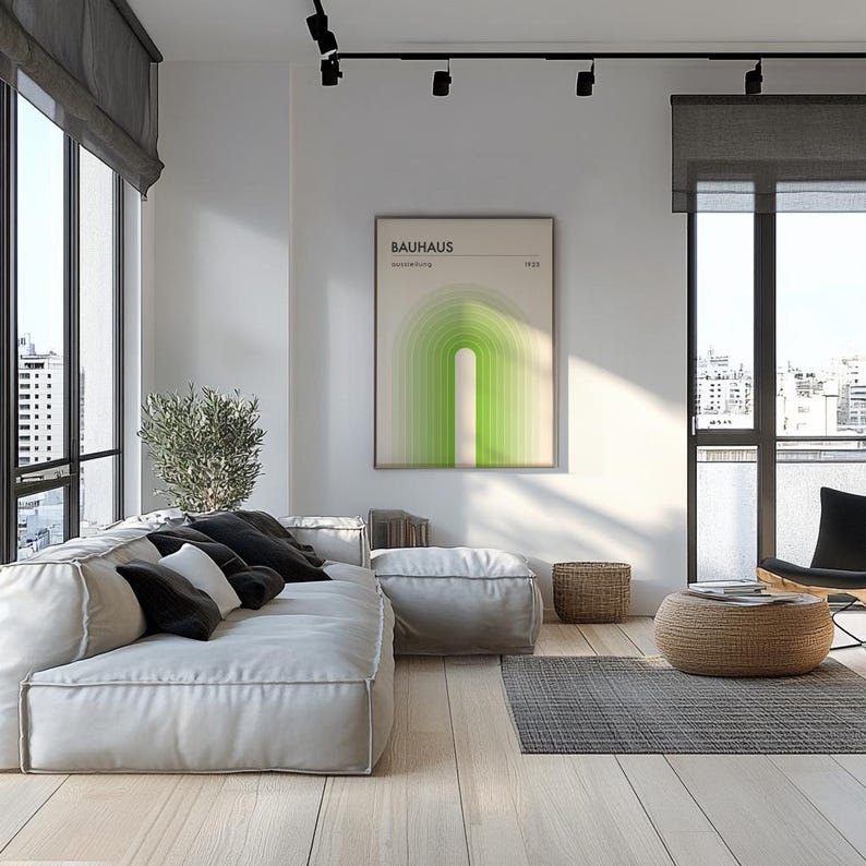 May include: A modern living room with a large sectional sofa, a coffee table, and a framed print with the text "BAUHAUS" and a geometric design in shades of green. The room has large windows with city views and a wood floor.